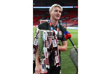 Ryan Watson with League 2 Play off trophy 2020