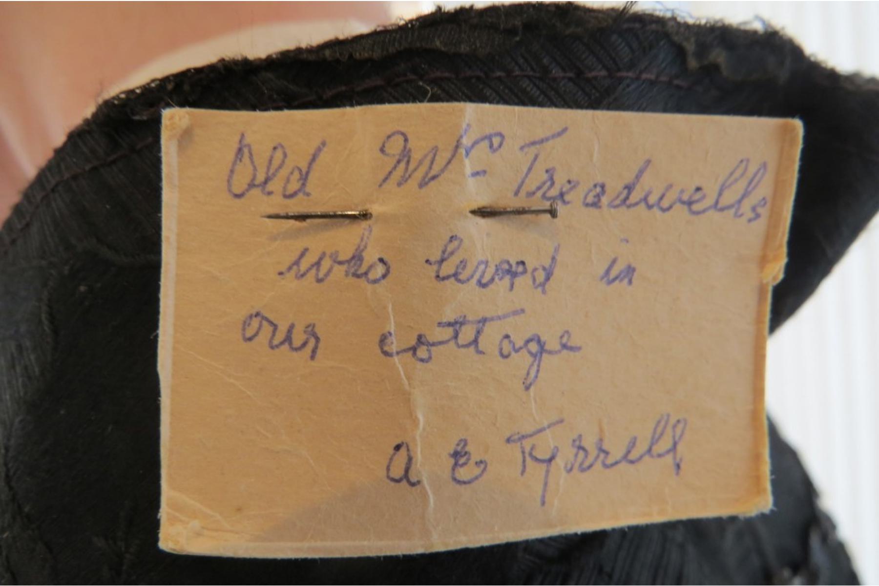 Close up of the label attached to the cape attesting to its making and ownership