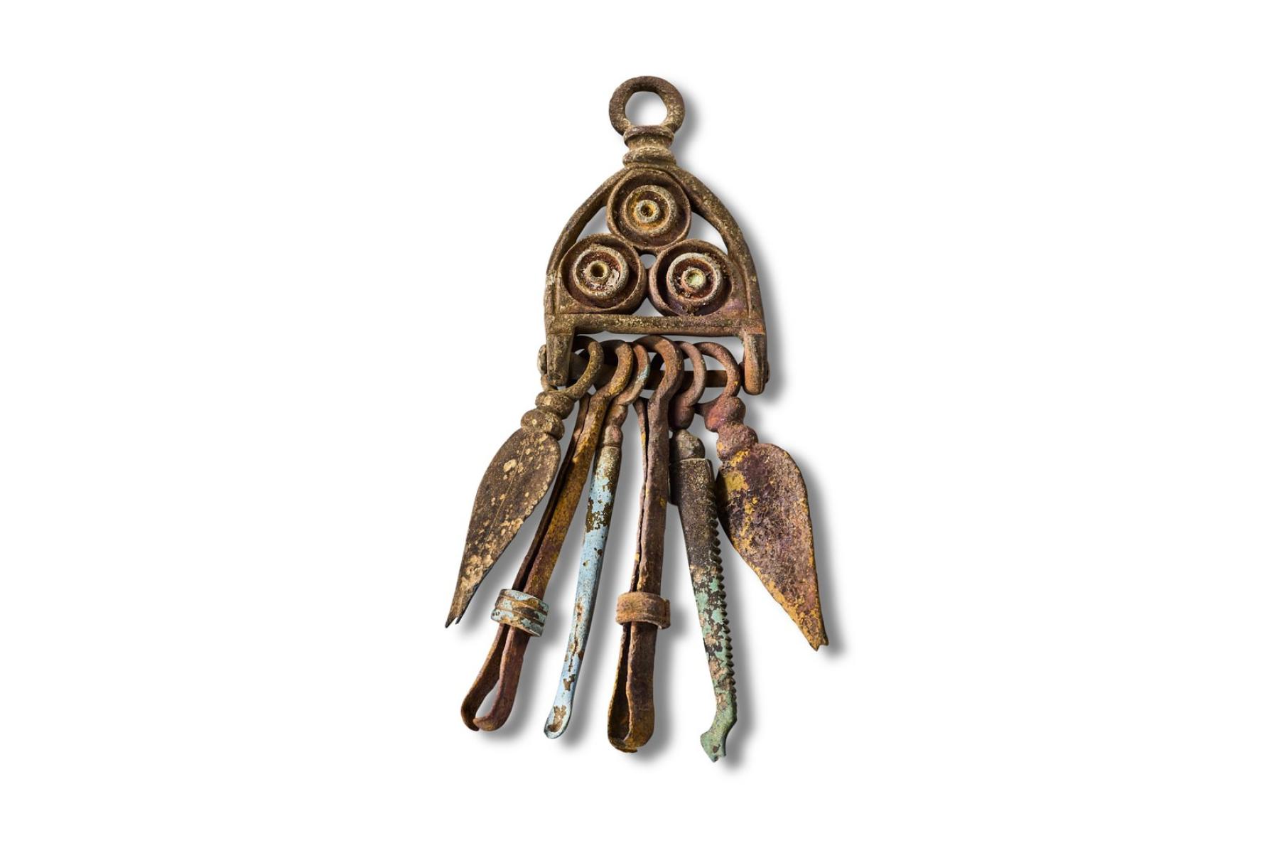 Bronze, enamelled Roman vanity set hung from a chatelaine
